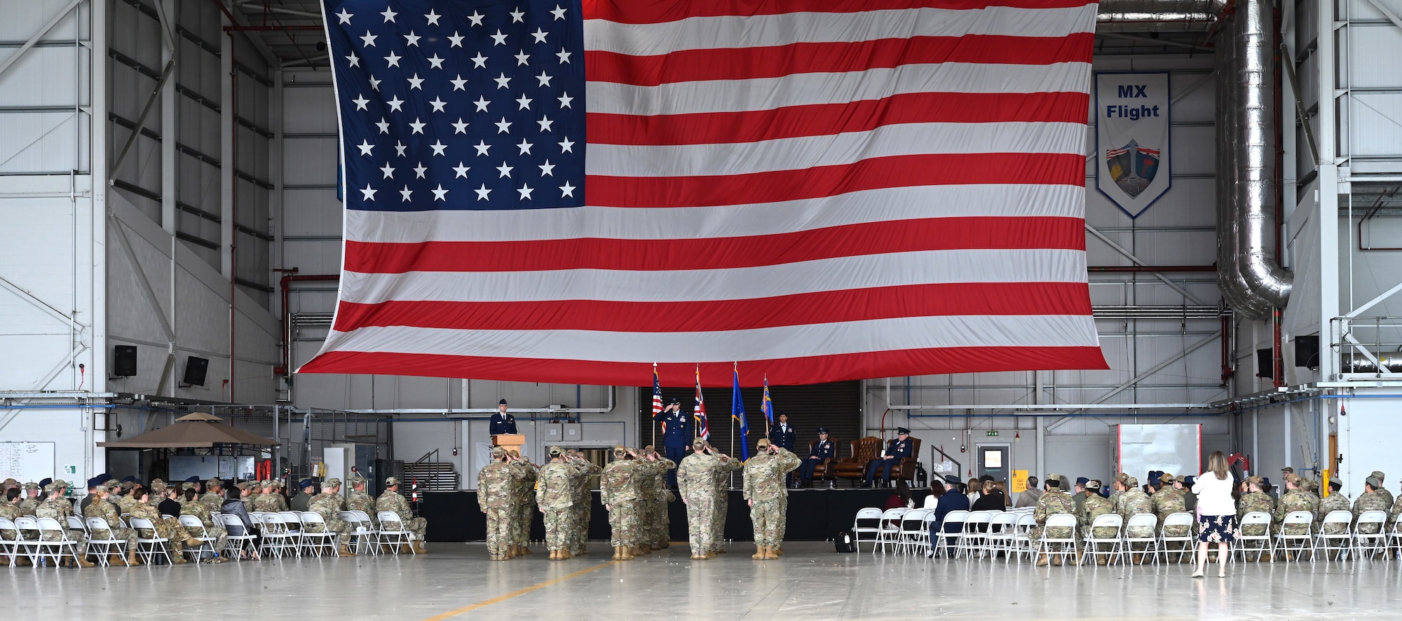 U.S. Air Force Col. Scott Korell, center, incoming 100th Operations Group commander, renders his first salute at the change of command ceremony at RAF Mildenhall, England, June 10, 2025.