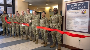 U.S. Air Force Col. Ann McManis, 87th Medical Group commander, is joined by other 87th MDG personnel as she cuts a ribbon marking the official launching of the Same Day Acute Care clinic at Joint Base McGuire-Dix-Lakehurst, N.J., April 28, 2025. Designed for non-life-threatening acute conditions, the Same Day Acute Care clinic addresses ailments such as colds, flu, sore throats, and minor injuries, and offers a walk-in, on-demand service with no appointment necessary. (U.S. Air Force photo by Susan Moriarty)