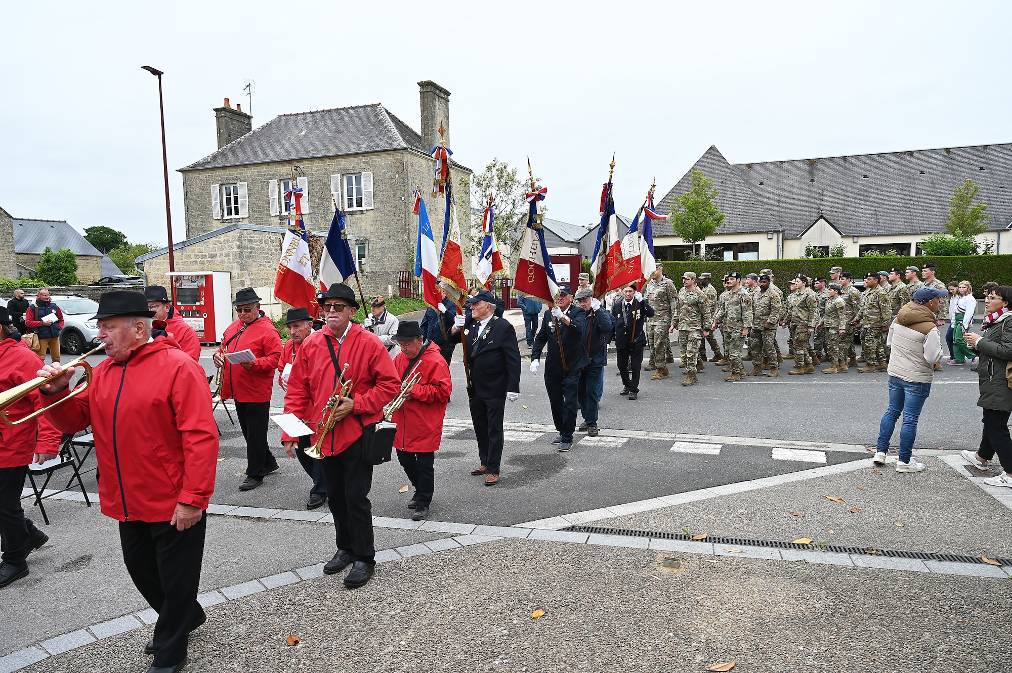 Members of the 435th Air Ground Operations Wing march in a ceremony procession with local community members in Nègreville, France, June 3, 2025. The ceremony highlighted the sacrifices of the crew and paratroopers of C-47 Skytrain that crashed during D-Day. (Photo by Capt Lou Burton, 435th AGOW Public Affairs)