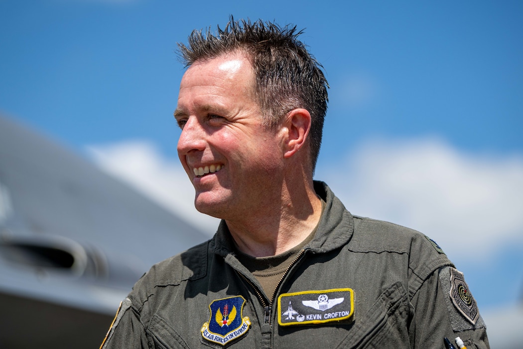 A pilot smiles at his family and friends after his final flight.