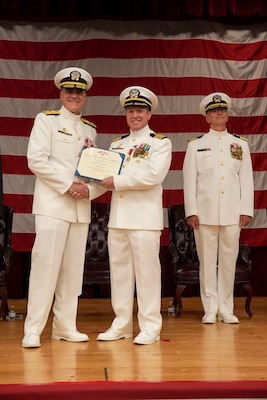 250609-O-NJ594-1010, Portsmouth, Virginia, (June 6, 2025) Portsmouth, Virginia, (June 6, 2025) Rear Adm. Kevin Brown, commander of Naval Medical Forces Atlantic, left, presents Capt. Marion Gregg, outgoing commander of Navy and Marine Corps Force Health Protection Command (NMCFHPC), former director of Defense Centers for Public Health Portsmouth (DCPH-P), center, with the Legion of Merit for his dedication and outstanding service as the commander of NMCFHPC and director of DCPH-P. During his tenure as commander of NMCFHPC, Gregg made several major impacts in support of the Navy including, leading modernization efforts for the forward deployed preventive medicine unit platform, including novel weapons and threat recognition training to ensure adaptable, operational support capabilities to the United States and joint forces globally. (U.S. Navy photo by Desmond Martin)