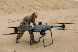 U.S. Army Spc. Dalton Herron, assigned to 1836th Transportation Company, inserts a battery into the Tactical Resupply Vehicle-150, during a Driving Innovation and Realistic Training event within the U.S. Central Command area of responsibility. (U.S. Army photo by Sgt. Alison Strout)