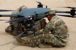 U.S. Army Spc. Marvin Mazariego and Spc. Dalton Herron, both assigned to 1836th Transportation Company, attach supplies to a Tactical Resupply Vehicle-150, during a Driving Innovation and Realistic Training event within the U.S. Central Command area of responsibility. (U.S. Army photo by Sgt. Alison Strout)