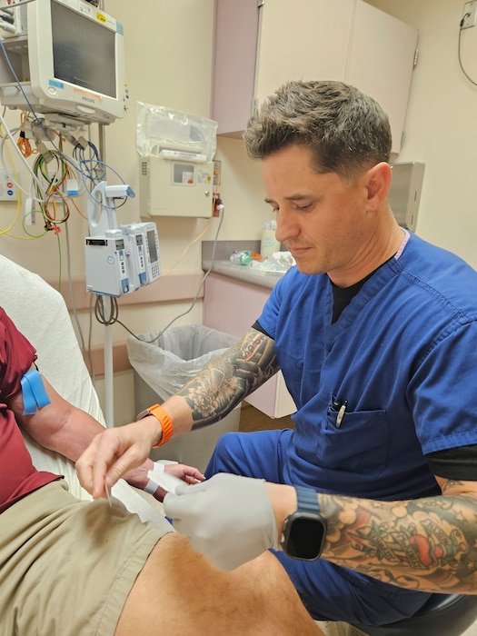 250603-N-ME175-1001 JACKSONVILLE, FL. (June 3, 2025) Lt. j.g. Michael Peters, registered nurse at Naval Hospital Jacksonville preps for a blood draw for a patient in the Emergency Room. Peters was among four nurses in the Navy chosen to attend the Perioperative Nurse Training Program. (U.S. Navy photo by Julie M. Lucas)