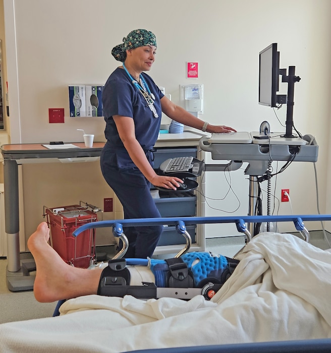 250604-N-ME175-1001 JACKSONVILLE, FL. (June 4, 2025) Lt. j.g. Milquella Fordyce, staff nurse at Naval Hospital Jacksonville tends to a patient in the Post Anesthesia Care Unit following surgery. Fordyce was recently chosen to attend the Navy's Perioperative Nurse Training Program. (U.S. Navy photo by Julie M. Lucas)