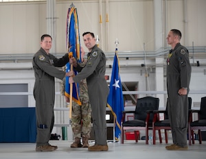 U.S. Air Force Maj. Gen. David Lyons, 15th Air Force commander presents Col. Brandon “Gringo” Tellez, outgoing 1st Fighter Wing commander, with the Legion of Merit during a change of command ceremony at the 71st Fighter Squadron, Langley Air Force Base, June 6, 2025. Throughout his command, Tellez drove the wing to achieve new levels of combat success such as setting historic Air Force records in F-22 sortie production, reviving William Tell and the Mitchell Trophy Air Race. (U.S. Air Force Tech. Sgt. Matthew Coleman-Foster)