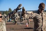 Colorado Army National Guard Pfc. Erich Bendele, Headquarters-Headquarters Company 1st Battalion 157th Infantry (MTN) and Staff Sgt. Raden Chambers, 3650th Support Maintenance Company, celebrate after completing a physical fitness task during the Region VII Best Warrior Competition, Camp Navajo, Arizona, May 13, 2025. The top lower enlisted Soldier and non-commissioned officer move on to compete at the national event later in the year. (U.S. Army National Guard photo by Sgt. 1st Class Joseph K. VonNida)