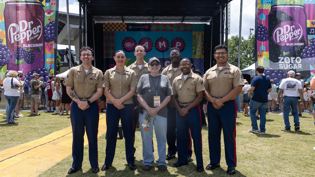U.S. Marines with 2d Marine Aircraft Wing band, Special-Purpose Marine Air-Ground Task Force 250, take a group photo at the Ascend Amphitheater for the Country Music Association Festival as part of Marine Week Nashville, in Nashville, Tennessee, June 8, 2025. CMA hosted 2d Marine Aircraft Wing band as a way to show support for the Marine Corps. Throughout 2025, Marines across the globe will celebrate the 250th birthday of the Corps, commemorating service, sacrifice, and priding themselves on living 'Semper Fidelis' or 'Always Faithful' to their nation and to each other.