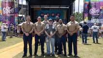 U.S. Marines with 2d Marine Aircraft Wing band, Special-Purpose Marine Air-Ground Task Force 250, take a group photo with a fan at the Ascend Amphitheater for the Country Music Association Festival as part of Marine Week Nashville, in Nashville, Tennessee, June 8, 2025. CMA hosted 2d Marine Aircraft Wing band as a way to show support for the Marine Corps. Throughout 2025, Marines across the globe will celebrate the 250th birthday of the Corps, commemorating service, sacrifice, and priding themselves on living 'Semper Fidelis' or 'Always Faithful' to their nation and to each other.