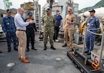 Christian Weber, the Integrated Battle Problem (IBP) 25.5 technology lead from Naval Surface Warfare Center Panama City Division, describes the capabilities of the Hangman underwater system to Japan Maritime Self-Defense Force Rear Adm. Yatsutaka Ebata, commander, Escort Flotilla 2, and Capt. Antonio Hyde, commodore, Mine Countermeasures Squadron 7, during the IBP 25.5 technology demonstration aboard the Avenger-class mine countermeasures ship USS Warrior (MCM 10), at Commander, Fleet Activities Sasebo, Japan, May 15, 2025. Exercises such as Integrated Battle Problem allow the Navy to demonstrate unmanned system operations in relevant experiment scenarios to meet service level objectives and operationalize unmanned systems and capabilities to maintain a secure and prosperous Indo-Pacific region. U.S. 7th Fleet, the U.S. Navy’s largest forward-deployed numbered fleet, routinely interacts and operates with allies and partners in preserving a free and open Indo-Pacific region. (U.S. Navy photo by Mass Communication Specialist 1st Class W. Chase Stephens. Portions of this photo have been obscured for security purposes.)