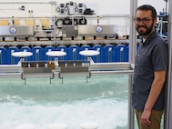 U.S. Naval Research Laboratory (NRL)-National Research Council (NRC) Postdoctoral Fellow with NRL’s Chemistry Division, Center for Corrosion Science and Engineering, Alex Johnson, next to symmetric airfoils used for measuring dry deposition of chloride and sulfate. This is used to study the impact of corrosion from saltwater aerosols at the NRL Laboratory for Autonomous Systems Research (LASR) Littoral Bay Wave Pool, in Washington, D.C., Sept. 24, 2024.