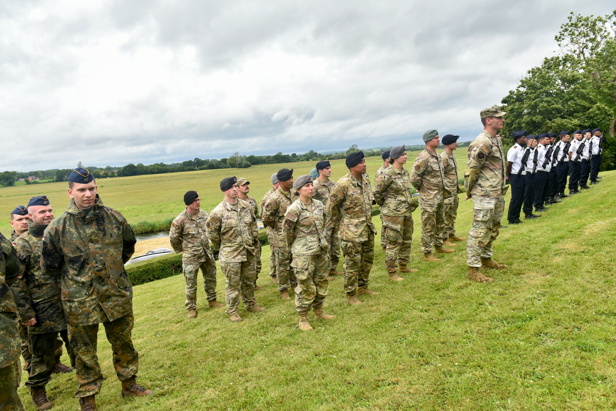 International servicemembers stand in formation