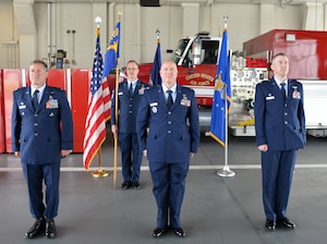 U.S. Air Force Col. Glyn Weir, left, Chief Master Sgt. Timothy Malloy, rear, Maj. Shaun Denton, center and Lt.Col. Kevin Lawhon, right, all assigned to the 106th Rescue Wing of the New York Air National Guard, stand at attention during a change of command ceremony, June 6, 2025, in the firehouse at Francis S. Gabreski Air National Guard Base in Westhampton Beach, N.Y.
