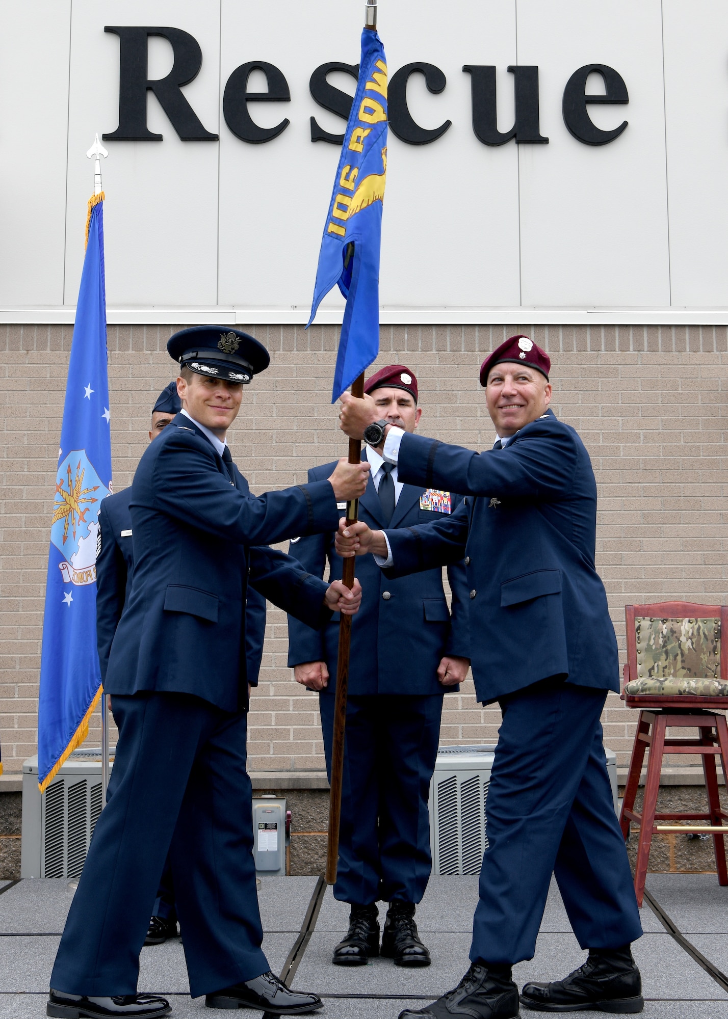 Col. Sean Garell, left, commander of the 106th Operations Group and U.S. Air Force Lt. Col. Marty Viera, right, incoming commander of the 103rd Rescue Squadron, hold the squadron guidon during the change of command ceremony at Francis S. Gabreski Air National Guard Base, Westhampton Beach, N.Y., June 7, 2025.