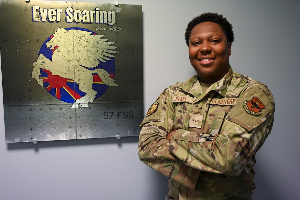U.S. Air Force Airman 1st Class Christopher Platt, 97th Force Support Squadron (FSS) force management technician, stands by the 97th FSS plaque at Altus Air Force Base, Oklahoma, May 29, 2025. Platt was awarded Airman of the Month for his outstanding performance and positive attitude in the workplace. (U.S. Air Force photo by Airman 1st Class Nathan Langston)