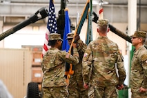 U.S. Army Lt. Col. Sheron Collins, incoming Army Field Support Battalion-Charleston commander, passes the flag to Sgt. 1st Class Shelbe Togba, Army Field Support Battalion-Charleston senior enlisted advisor, during the AFSBn-CHS change of command ceremony at Joint Base Charleston.