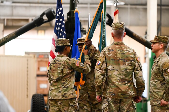 U.S. Army Lt. Col. Sheron Collins, incoming Army Field Support Battalion-Charleston commander, passes the flag to Sgt. 1st Class Shelbe Togba, Army Field Support Battalion-Charleston senior enlisted advisor, during the AFSBn-CHS change of command ceremony at Joint Base Charleston.