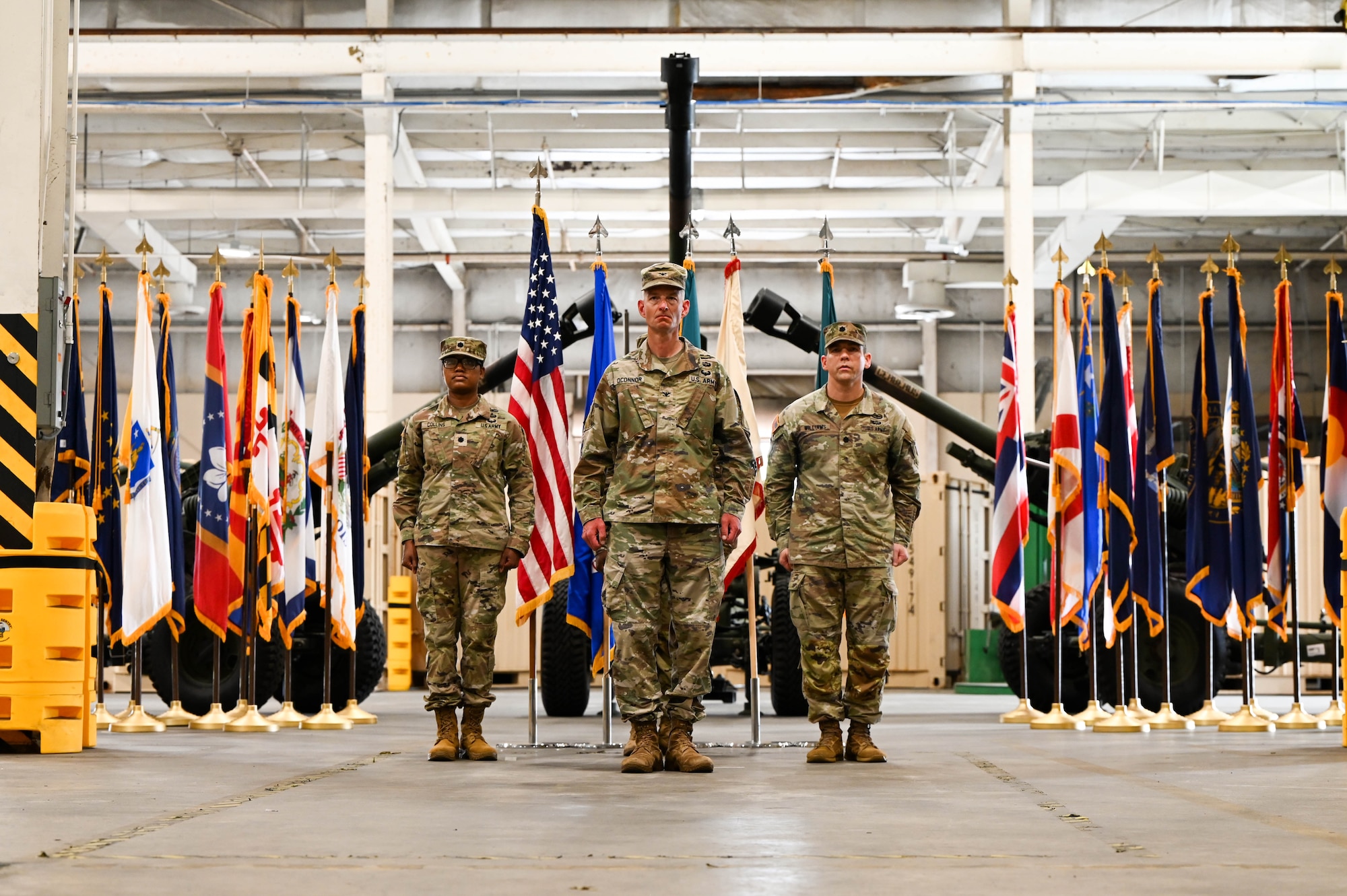 U.S. Army Lt. Col. Sheron Collins, incoming Army Field Support Battalion-Charleston commander, Col. Jeremiah O’Conner, 404th Army Field Support Brigade commander, and Col. Stuart Williams, Army Field Support Battalion-Charleston outgoing commander, stand at attention following the transfer of the flag during the AFSBn-CHS change of command ceremony at Joint Base Charleston.