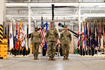 U.S. Army Lt. Col. Sheron Collins, incoming Army Field Support Battalion-Charleston commander, Col. Jeremiah O’Conner, 404th Army Field Support Brigade commander, and Col. Stuart Williams, Army Field Support Battalion-Charleston outgoing commander, stand at attention following the transfer of the flag during the AFSBn-CHS change of command ceremony at Joint Base Charleston.