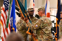 U.S. Army Lt. Col. Sheron Collins, incoming Army Field Support Battalion-Charleston commander, receives the flag from Col. Jeremiah O’Conner, 404th Army Field Support Brigade commander, during the AFSBn-CHS change of command ceremony at Joint Base Charleston.