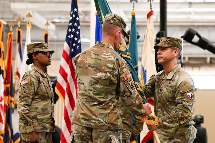 U.S. Army Lt. Col. Stuart Williams, outgoing Army Field Support Battalion-Charleston commander, passes the flag to Col. Jeremiah O’Conner, 404th Army Field Support Brigade commander, during the AFSBn-CHS change of command ceremony at Joint Base Charleston.