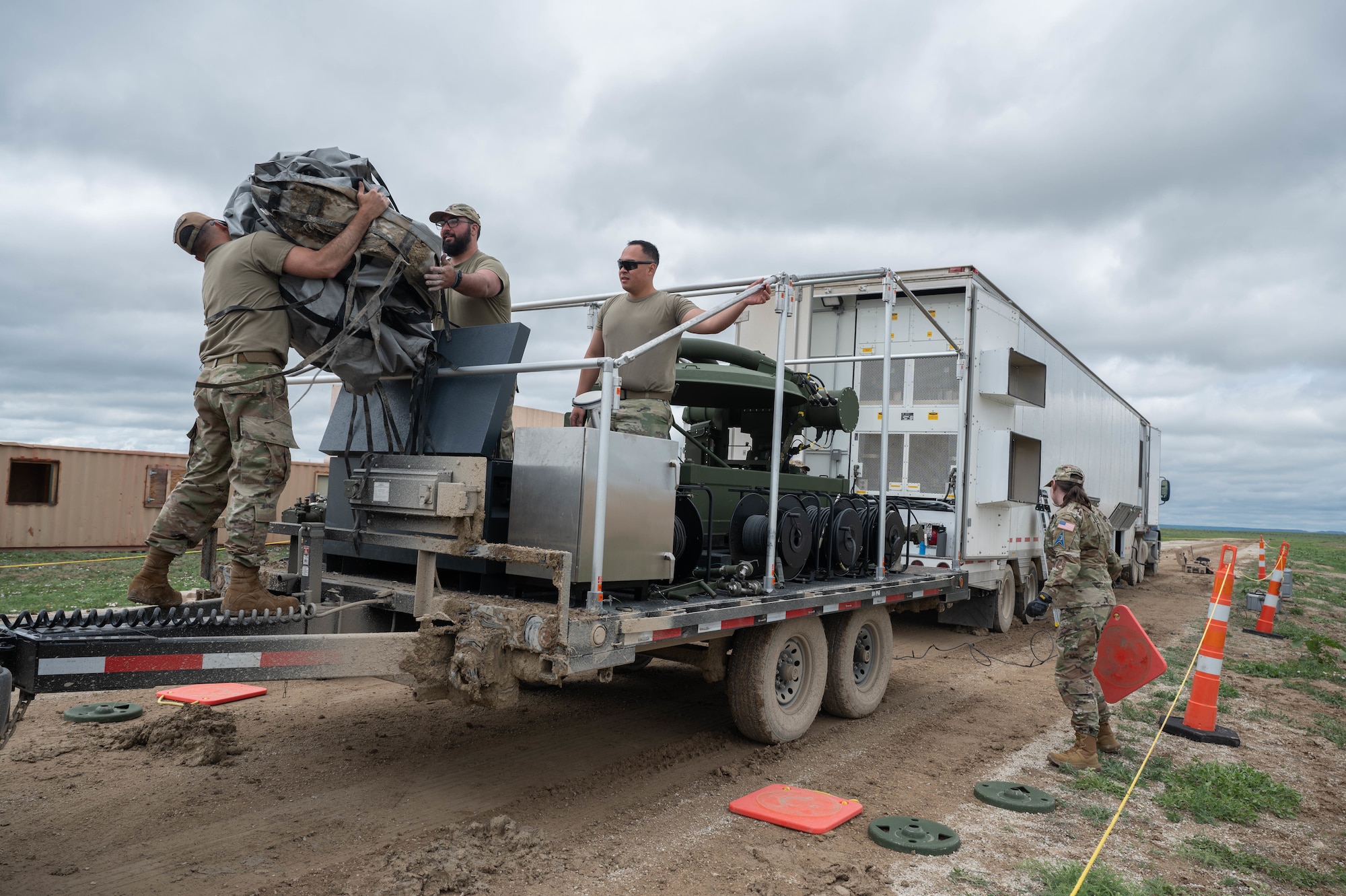 Members of the 4th Space Operations Squadron unload and set up equipment.