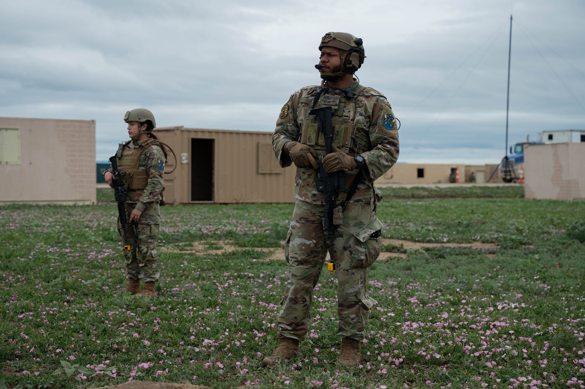 Two security forces members stand guard during an exercise.