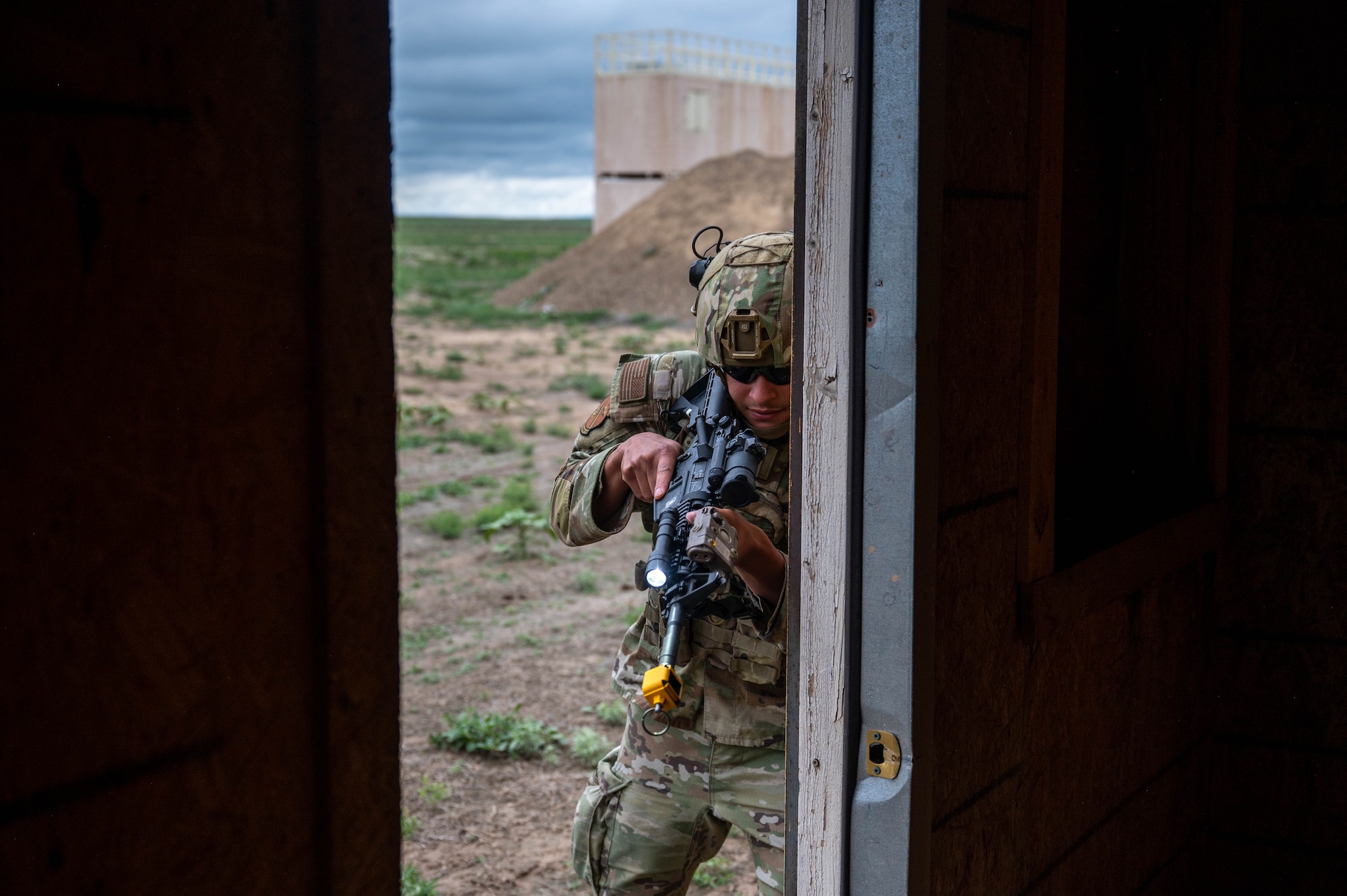 Airman with rifle enters a room
