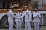 During the change of command ceremony for U.S. Coast Guard Cutter Active (WMEC 618), Cmdr. Earl Potter and Cmdr. Adam Disque shook hands, Sunday, Jun. 8, in San Diego. Rear Adm. Joanna Hiigel, deputy commander of Coast Guard Pacific Area, presided over the ceremony.  Under Disque’s leadership, Active deployed to the Eastern Pacific Ocean in support of counternarcotics efforts, search and rescue and territorial integrity. (U.S. Coast Guard photo by Lt. Karen Hovey)