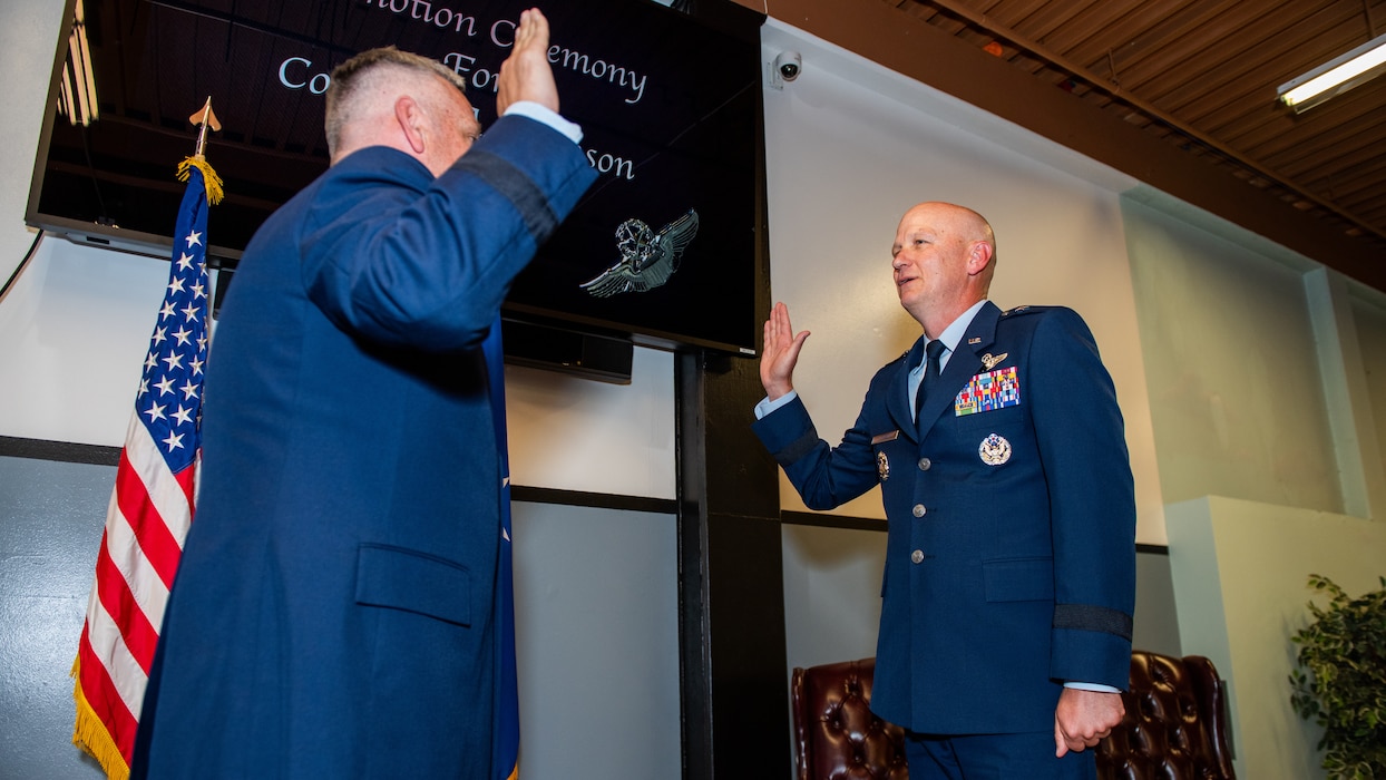 General administers the oath of office to a newly promoted general