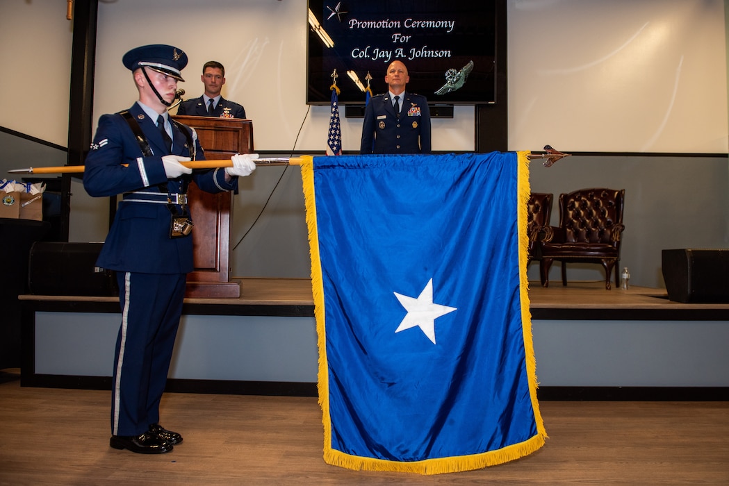 Airman unfurls general's personal flag