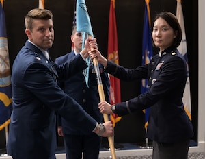 U.S. Space Force Lt. Col. Adam P. Jodice, 533rd Training Squadron commander, left, passes the 533rd TRS, Detachment 1 guidon to Maj. Uiri Han, right, incoming commander, during the 533rd TRS, Detachment 1 Change of Command Ceremony at the Powell Event Center, Goodfellow Air Force Base, Texas, June 10, 2024. Han took command as the third commander since the activation of the 533rd TRS Detachment 1.(U.S. Air Force photo by Senior Airman Evelyn J. D’Errico)