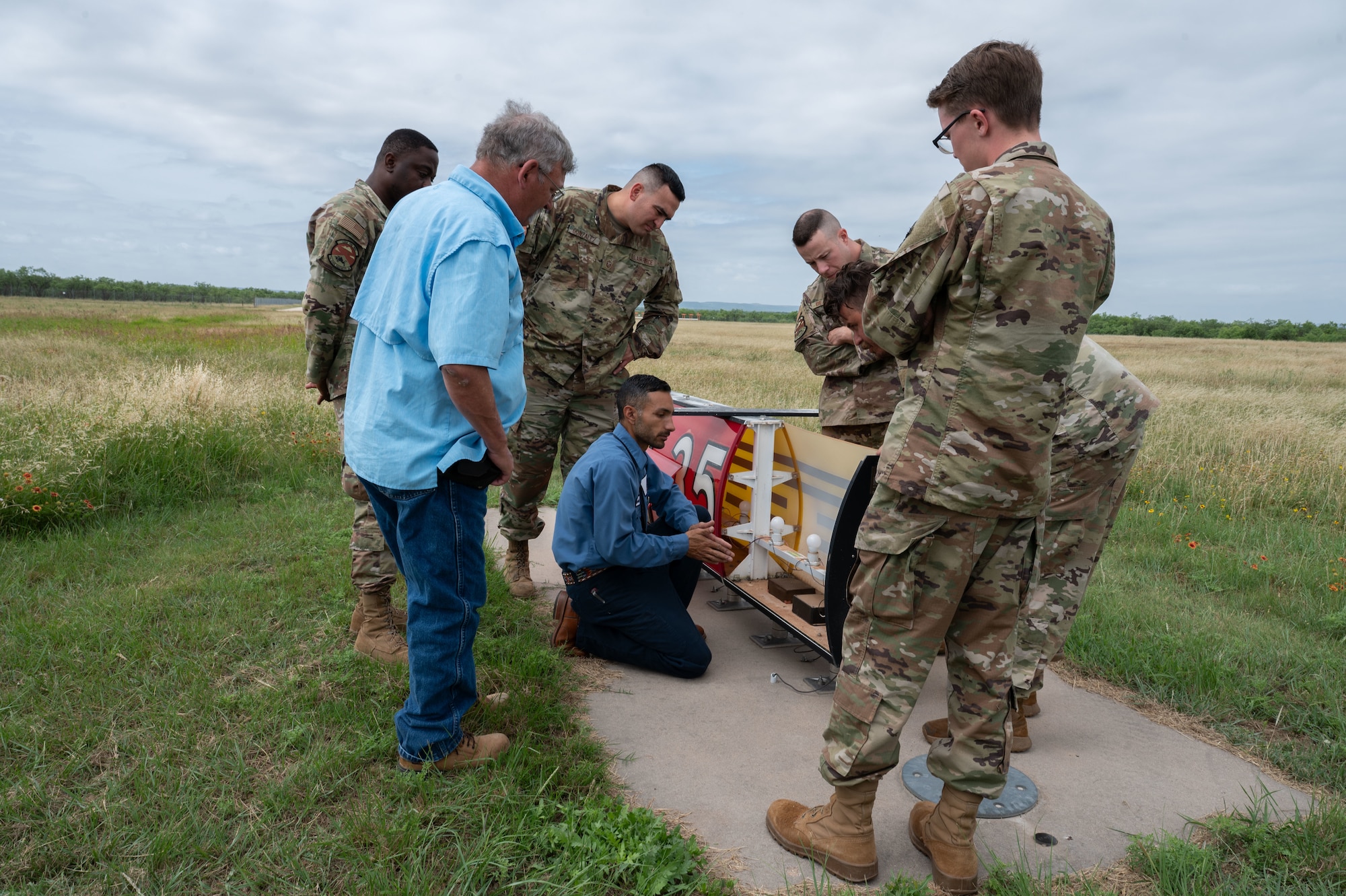 Members of the 7th Civil Engineer Squadron discuss electrical airfield lighting components during a collaborative training event at the Abilene Regional Airport, June 6, 2025. This partnership bolsters the 7th CES electrical team's ability to maintain peak operational performance through shared learning and best practices. (U.S. Air Force photo by Senior Airman Alondra Cristobal Hernandez)