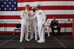 Capt. Lawrence Gaillard (right), outgoing Air Station Borinquen commanding officer, shakes hands with Air Station Borinquen’s new commanding officer, Capt. Jeffrey P. Owens (left), and Capt. Willie L. Carmichael, Seventh Coast Guard District chief of staff (center), during the unit’s change of command ceremony in Aguadilla, Puerto Rico June 11, 2025. (U.S. Coast Guard photo courtesy of Coast Guard Auxiliarist Oscar Salinas)