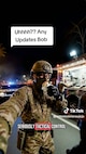 AI-generated man wearing a camoflage uniform appearing to hold a phone offscreen.
