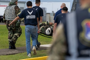 U.S. Airmen assigned to the 156th Civil Engineer Squadron, Puerto Rico Air National Guard, carry a simulated casualty during the Prime BEEF day exercise at Muñiz Air National Guard Base, Carolina, Puerto Rico, June 8, 2025. The exercise tested the 156th CES operational readiness and response to several structural incidents due to a simulated enemy aerial attack. (U.S. Air National Guard photo by Senior Airman Victoria A. Jewett)