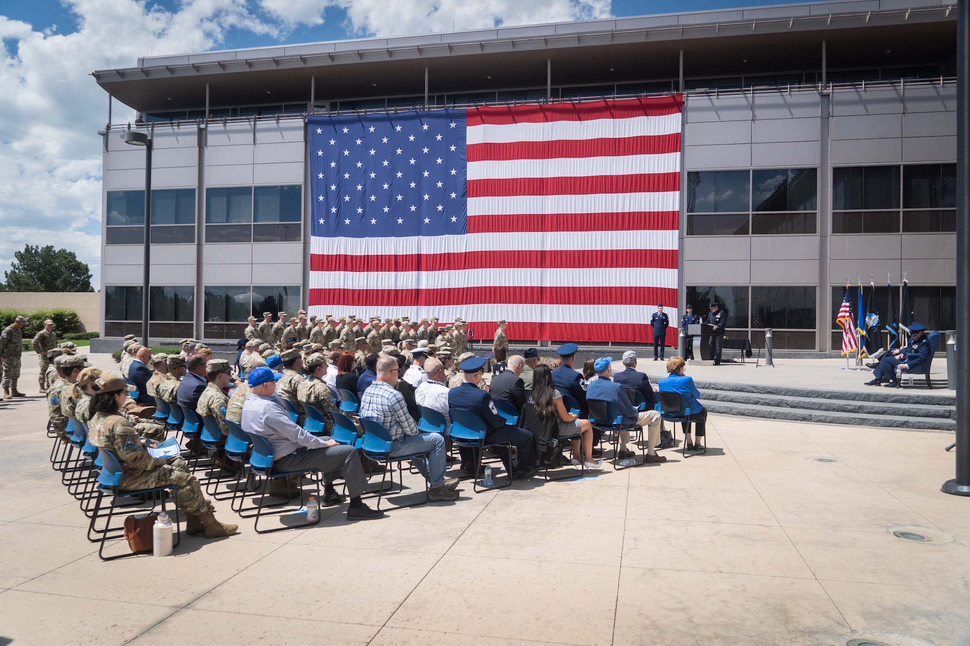 Change of command with flags, Space Fore uniforms and a podium.