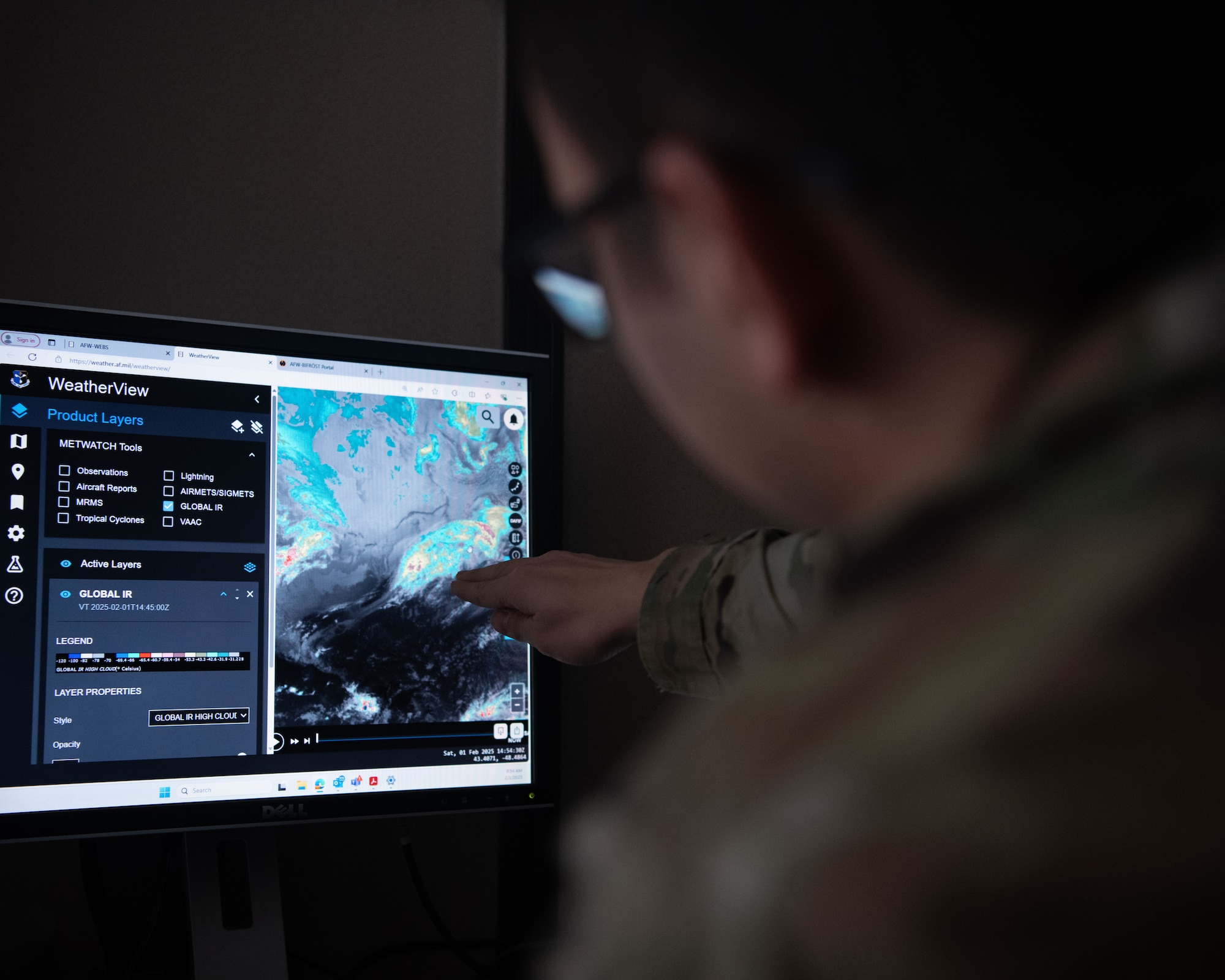 Airman pointing at weather map on computer screen