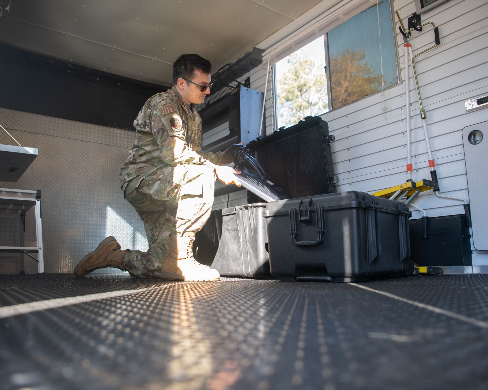 Airman pulling gear out of pelican case.