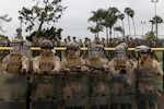 Marines holding protective shields