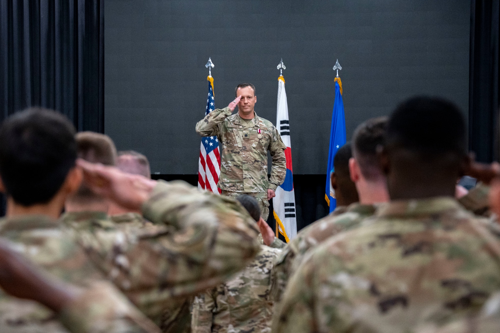 U.S. Air Force Lt. Col. Adam Fossum, outgoing 6th Intelligence Squadron commander, renders his final salute during the 6th IS Change of Command ceremony at Osan Air Base, Republic of Korea, June 11, 2025.