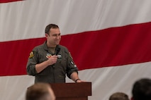 An Airman speaks into a microphone.