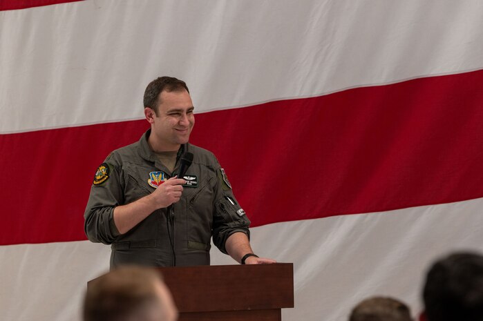 An Airman speaks into a microphone.