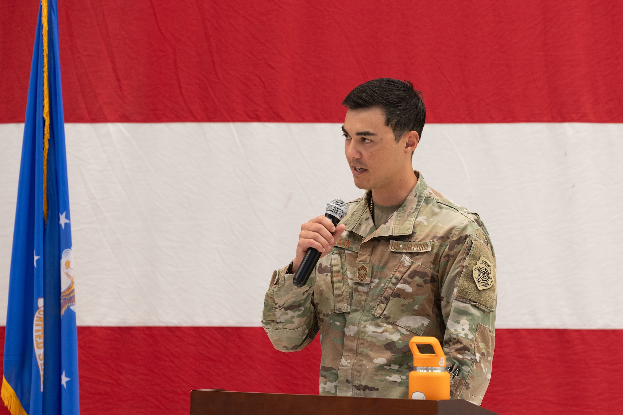 An Airman speaks into a microphone.