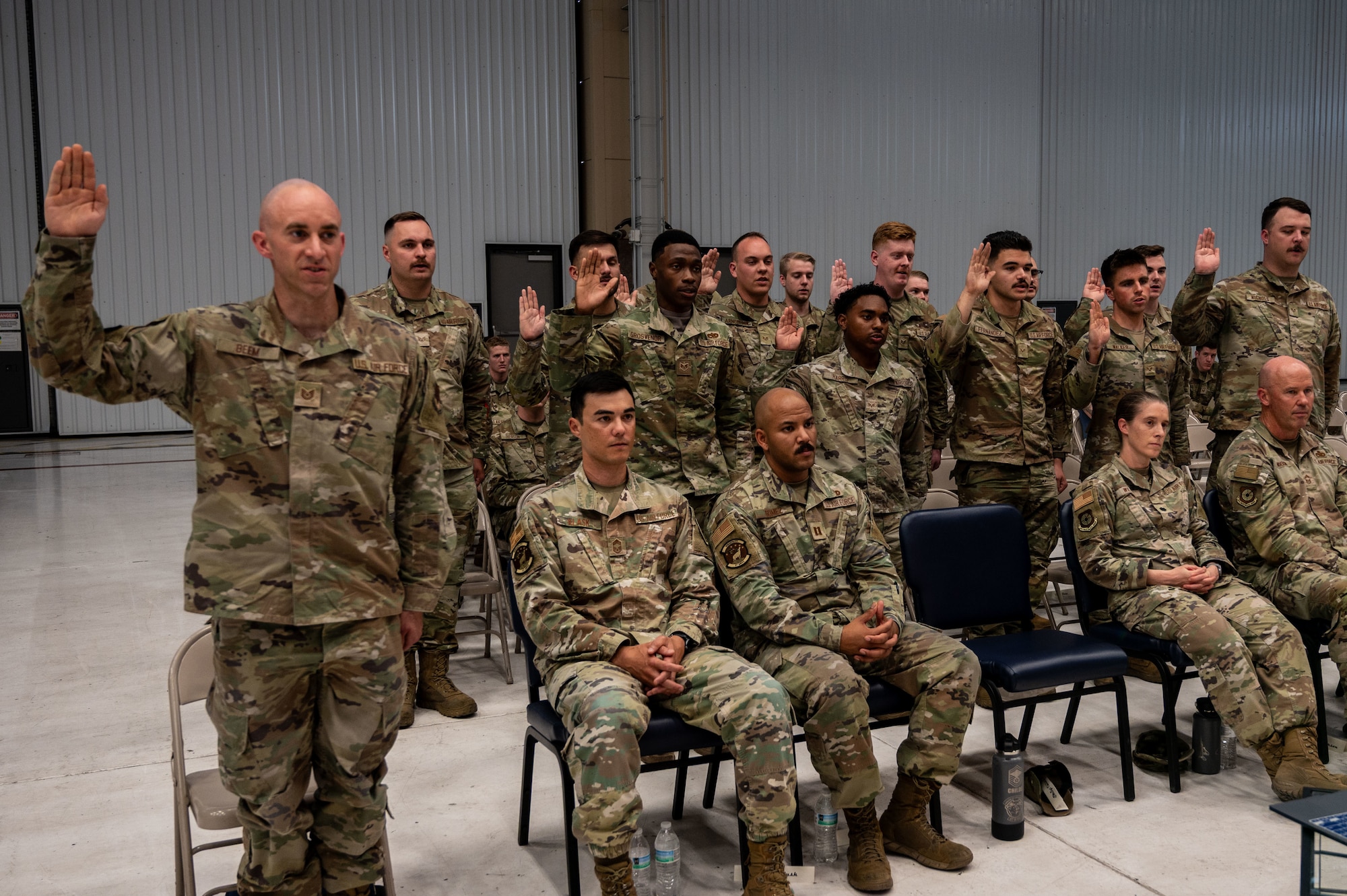 Airmen raise their right hand.