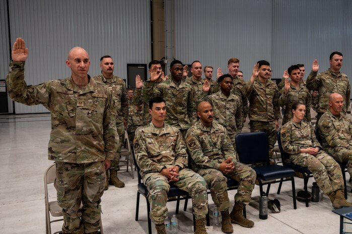Airmen raise their right hand.