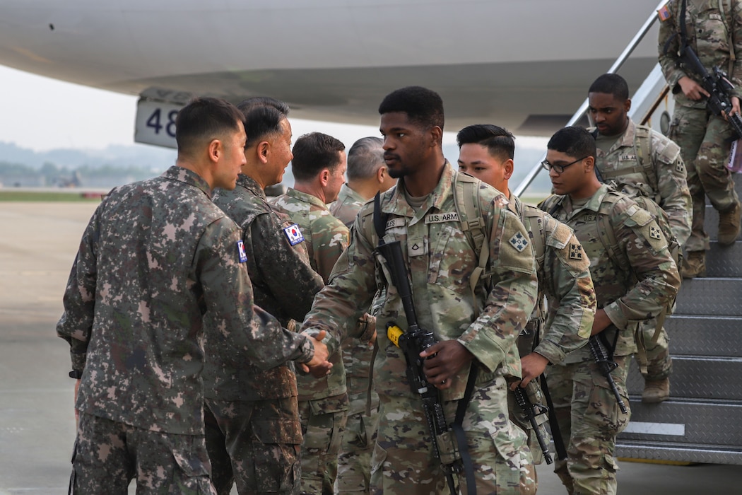 Republic of Korea Army Soldiers greet 1st Stryker Brigade Combat Team, 4th Infantry Division, Soldiers as they come off the plane at Osan Air Base, South Korea, May 30, 2025.