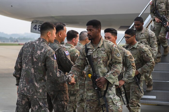 Republic of Korea Army Soldiers greet 1st Stryker Brigade Combat Team, 4th Infantry Division, Soldiers as they come off the plane at Osan Air Base, South Korea, May 30, 2025.