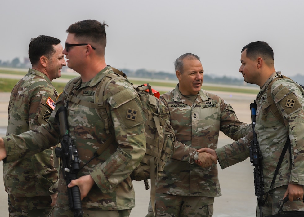 Major Gen. Charles Lombardo, 2nd Infantry Division commanding general (center right), greets 1st Stryker Brigade Combat Team, 4th Infantry Division, Soldiers as they come off the plane at Osan Air Base, South Korea, May 30, 2025.