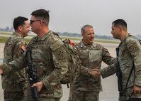 Major Gen. Charles Lombardo, 2nd Infantry Division commanding general (center right), greets 1st Stryker Brigade Combat Team, 4th Infantry Division, Soldiers as they come off the plane at Osan Air Base, South Korea, May 30, 2025.